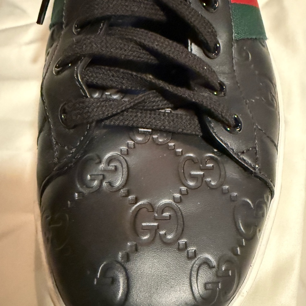 Gucci sneakers for men with embossed gucci logo. Shown in size 11